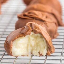close up shot of coconut chocolate balls on a cooling rack
