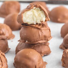 close up shot of coconut chocolate balls stacked on top of each other
