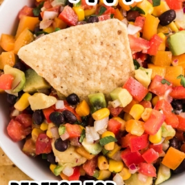 a bowl of Cowboy Caviar with a tortilla chip on top