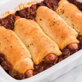close up shot of a baking dish of Baked Chili Dogs