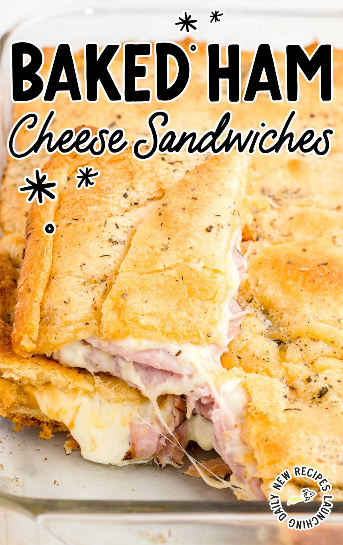 close up shot of a baking dish of Baked Ham and Cheese Sandwiches