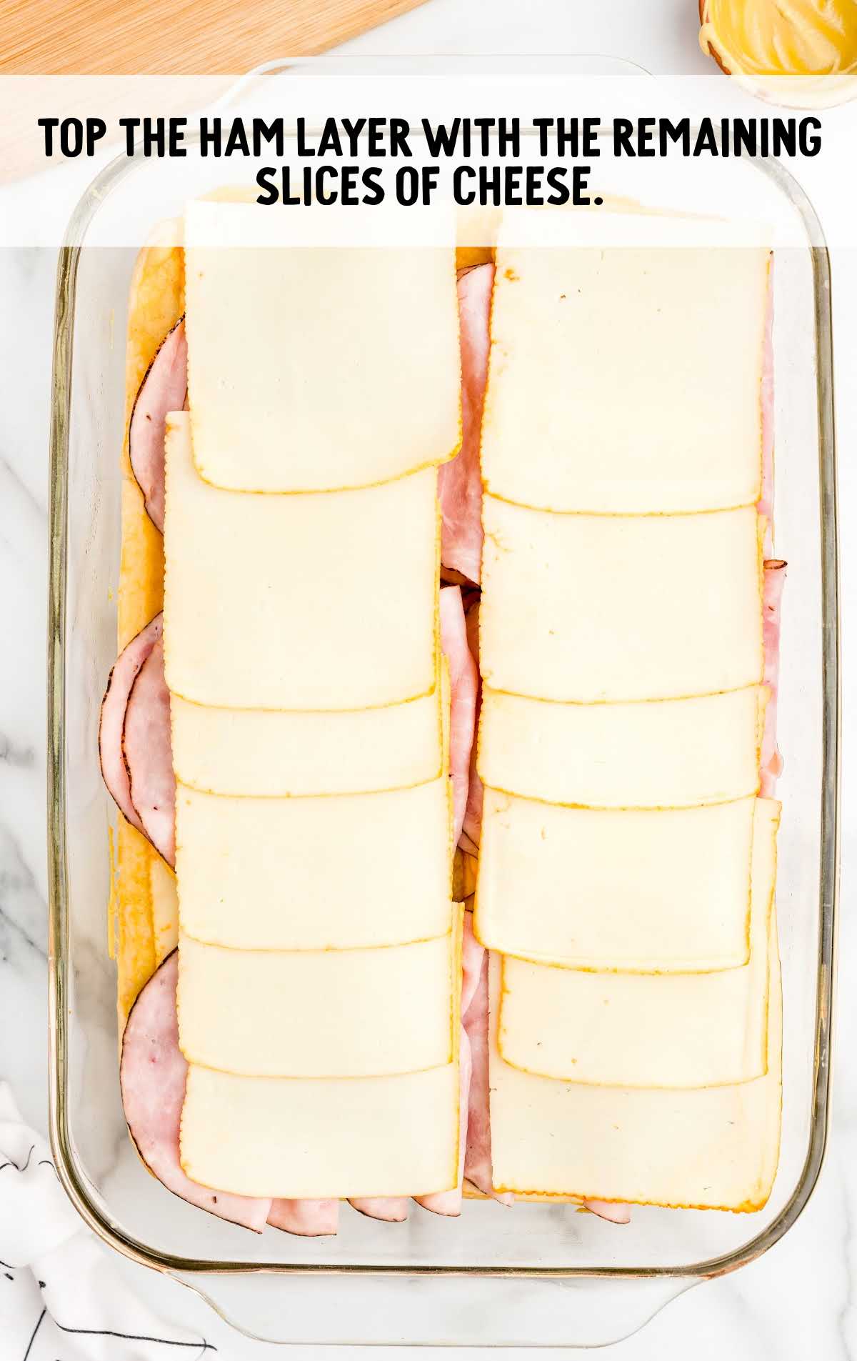Baked Ham and Cheese Sandwiches process shot of cheese spread on top of the sliced ham