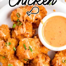close up overhead shot of a plate of Bang Bang Chicken garnished with green onions and served with a mayo sauce