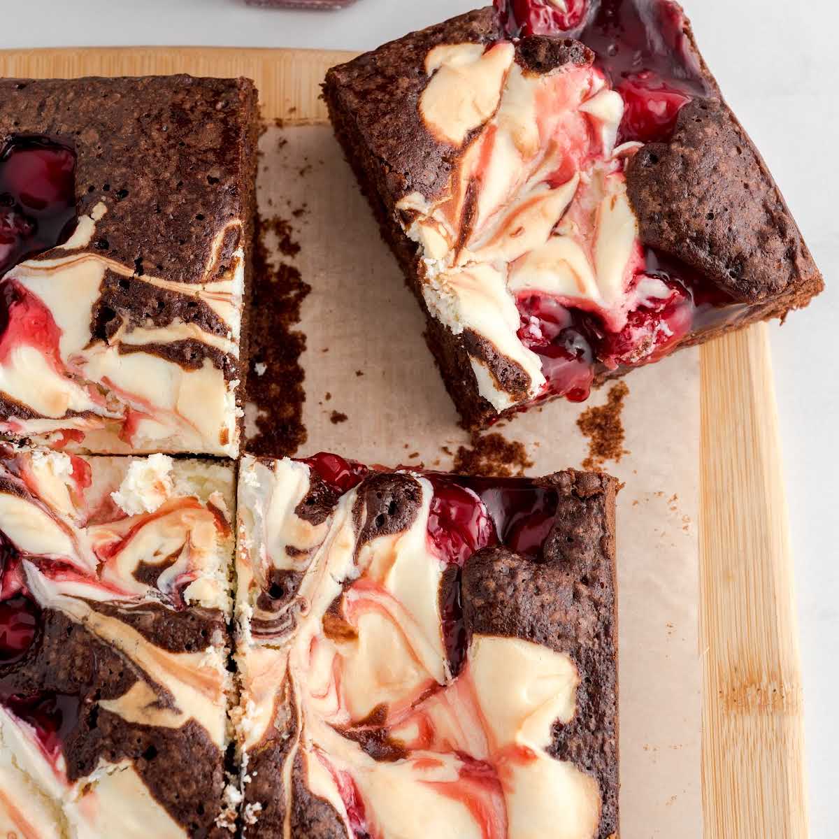 close up overhead shot of Cherry Cheesecake Brownie on a wooden board