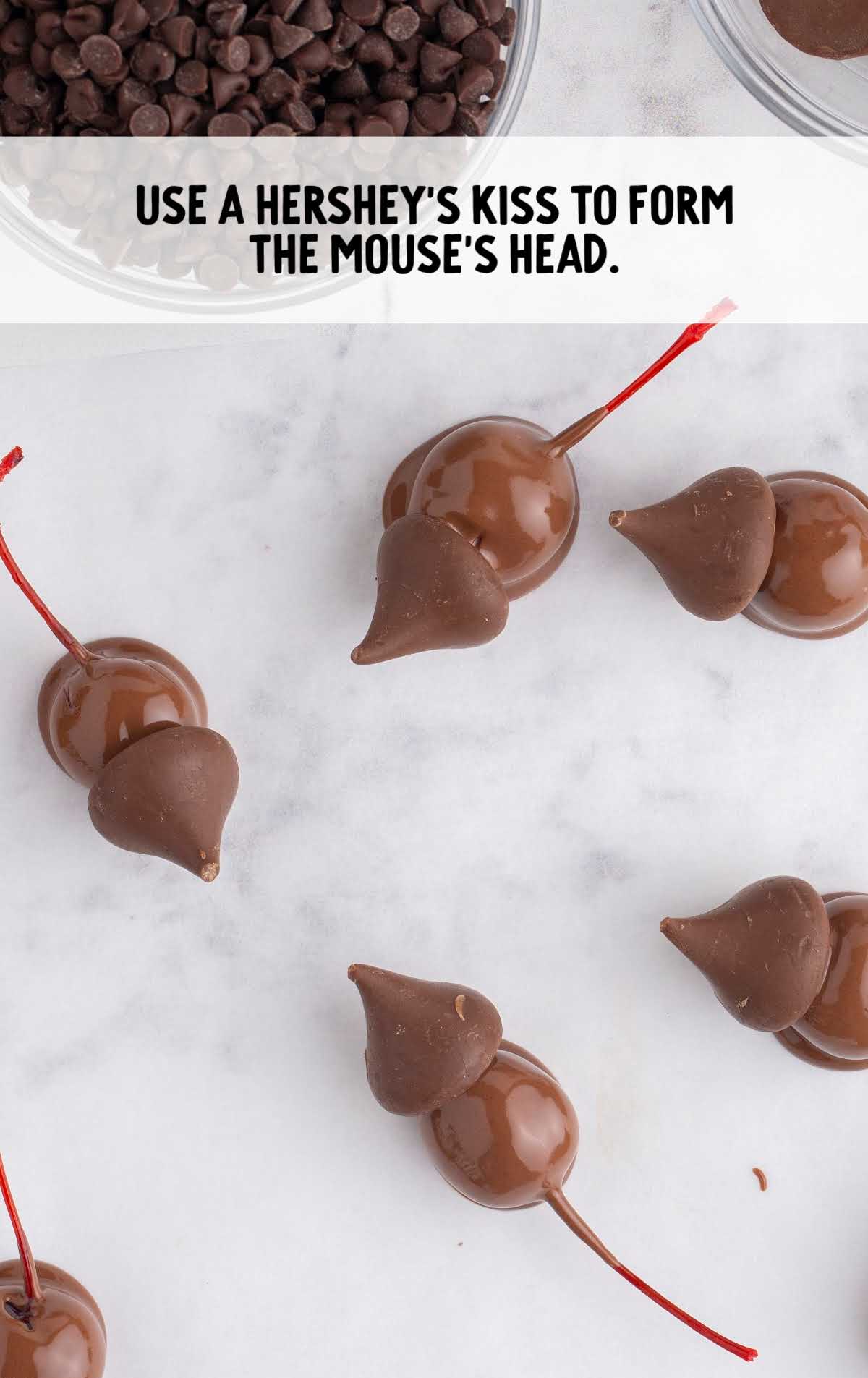 Hershey's kisses placed on top of the chocolate-dipped cherries