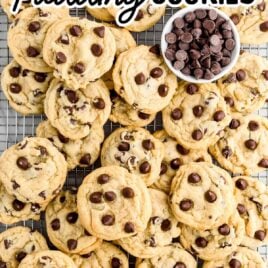 close up overhead shot of Chocolate Chip Pudding Cookies piled on a cooling rack with a bowl of chocolate chips