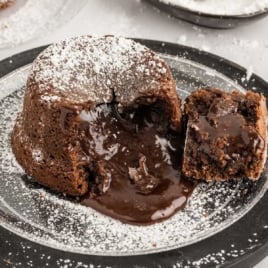 close up shot of a plate of Chocolate Lava Cake sprinkled with powdered sugar