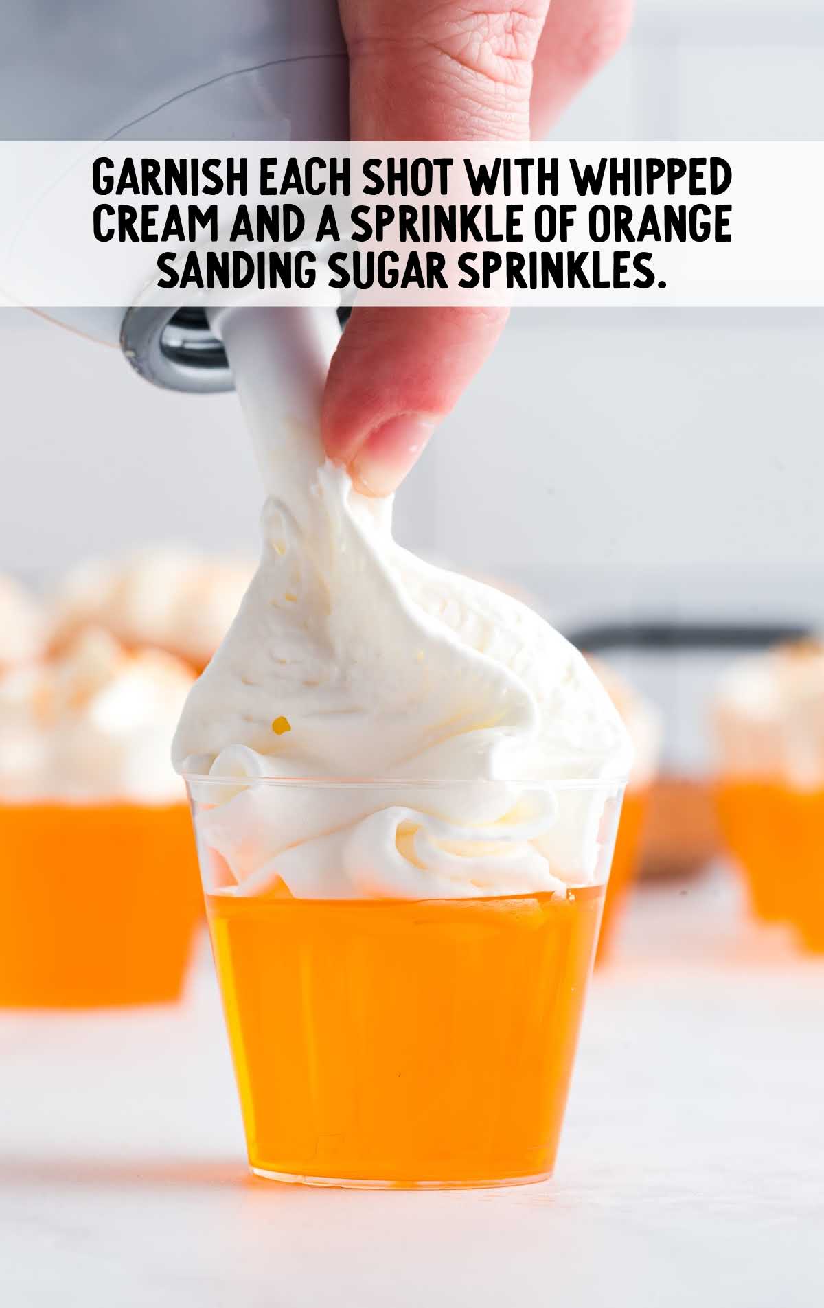 whipped cream and garnished with orange sprinkles