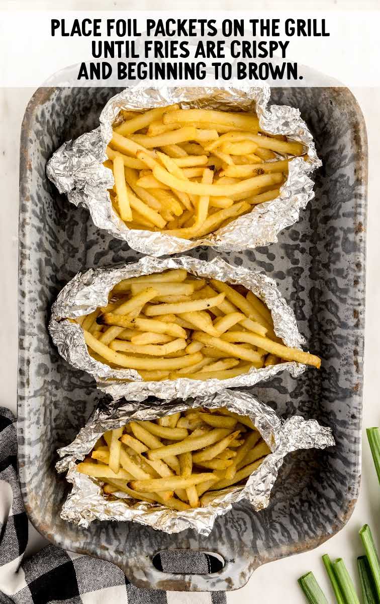 aluminum foiled wrapped fries placed on a pan
