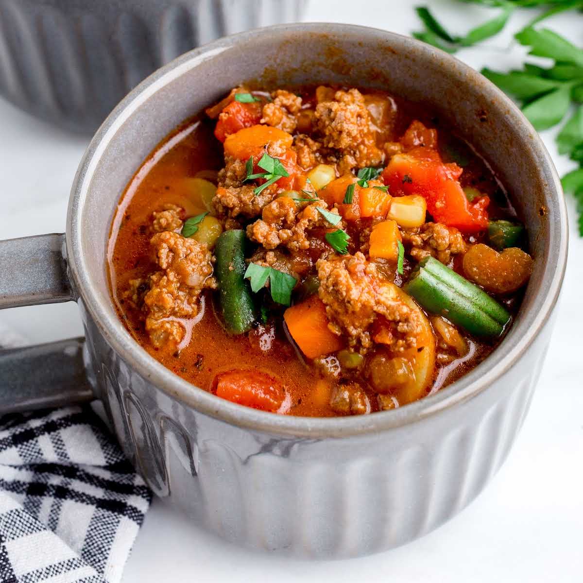 close up shot of a soup cup of Hamburger Stew