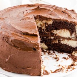 close up shot of Marble Cake with a slice missing and a slice of marble cake in the back