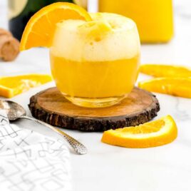 ot of a glass of Mimosa Float garnished with a orange slice