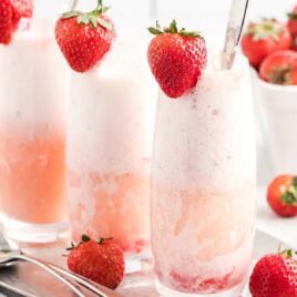 close up shot of glasses of Strawberry Champagne Floats garnished with strawberries