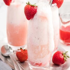 close up shot of glasses of Strawberry Champagne Floats garnished with strawberries