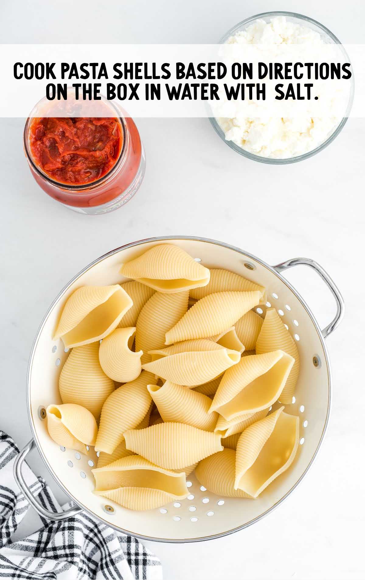 Stuffed Shells process shot of cooked pasta shells in a drainer