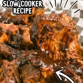 close up shot of a plate of slow cooker country style pork ribs topped with bbq sauce
