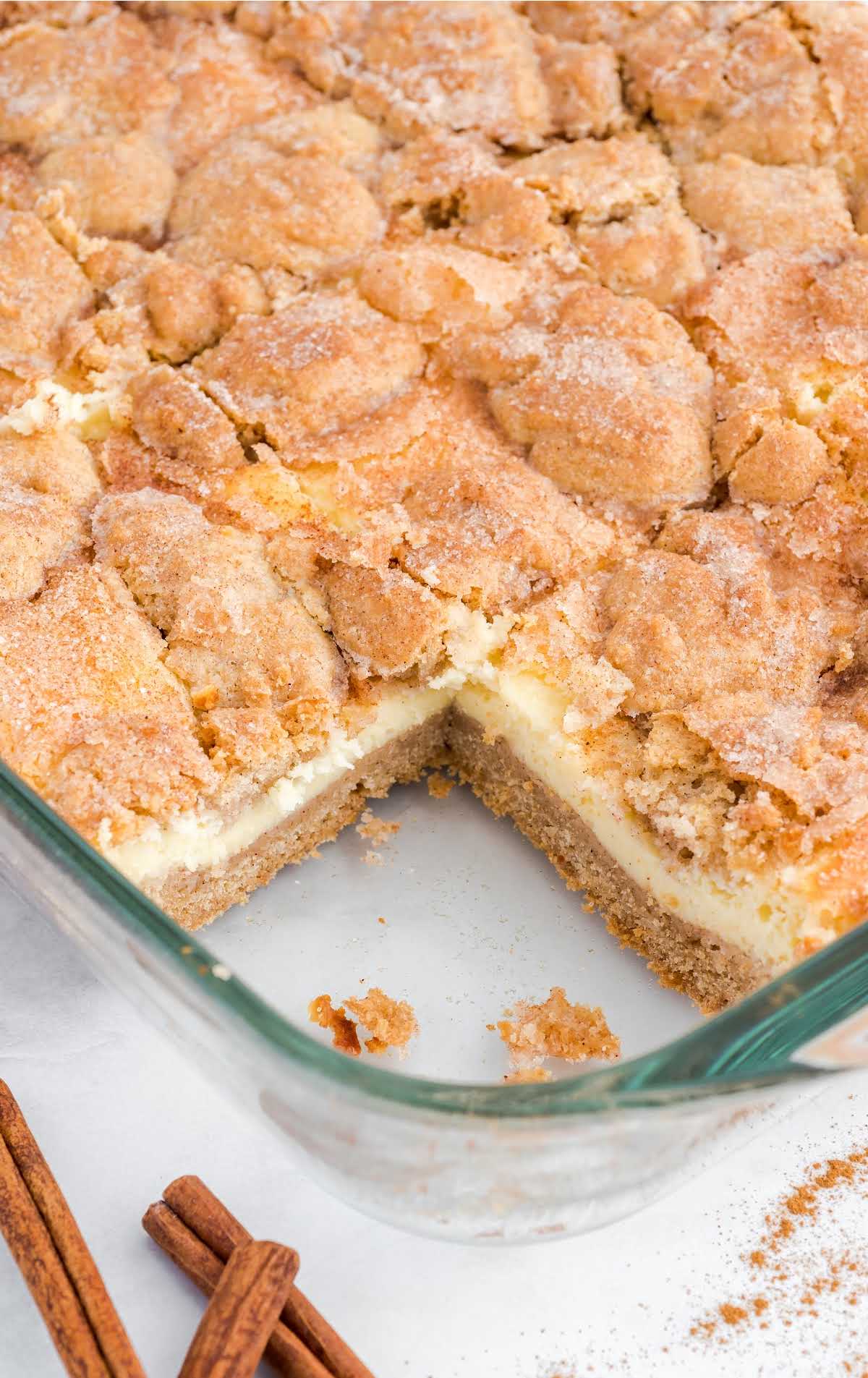 close up shot of snickerdoodle cheesecake bars in a baking dish