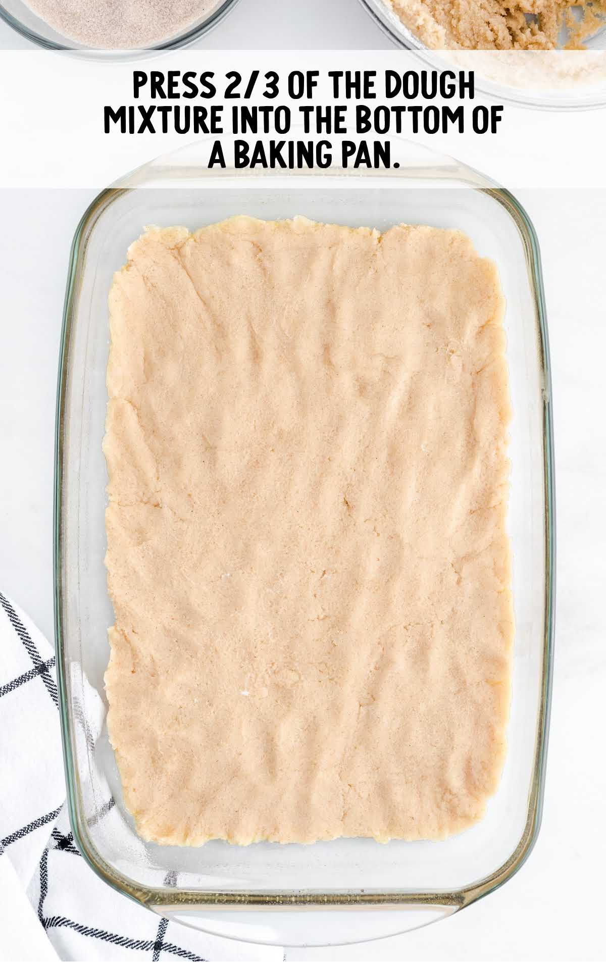 snickerdoodle cheesecake bars process shot of dough placed in a baking dish