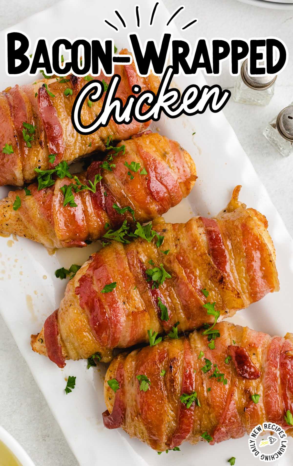 overhead shot of a serving tray of Bacon-Wrapped Chicken garnished with parsley