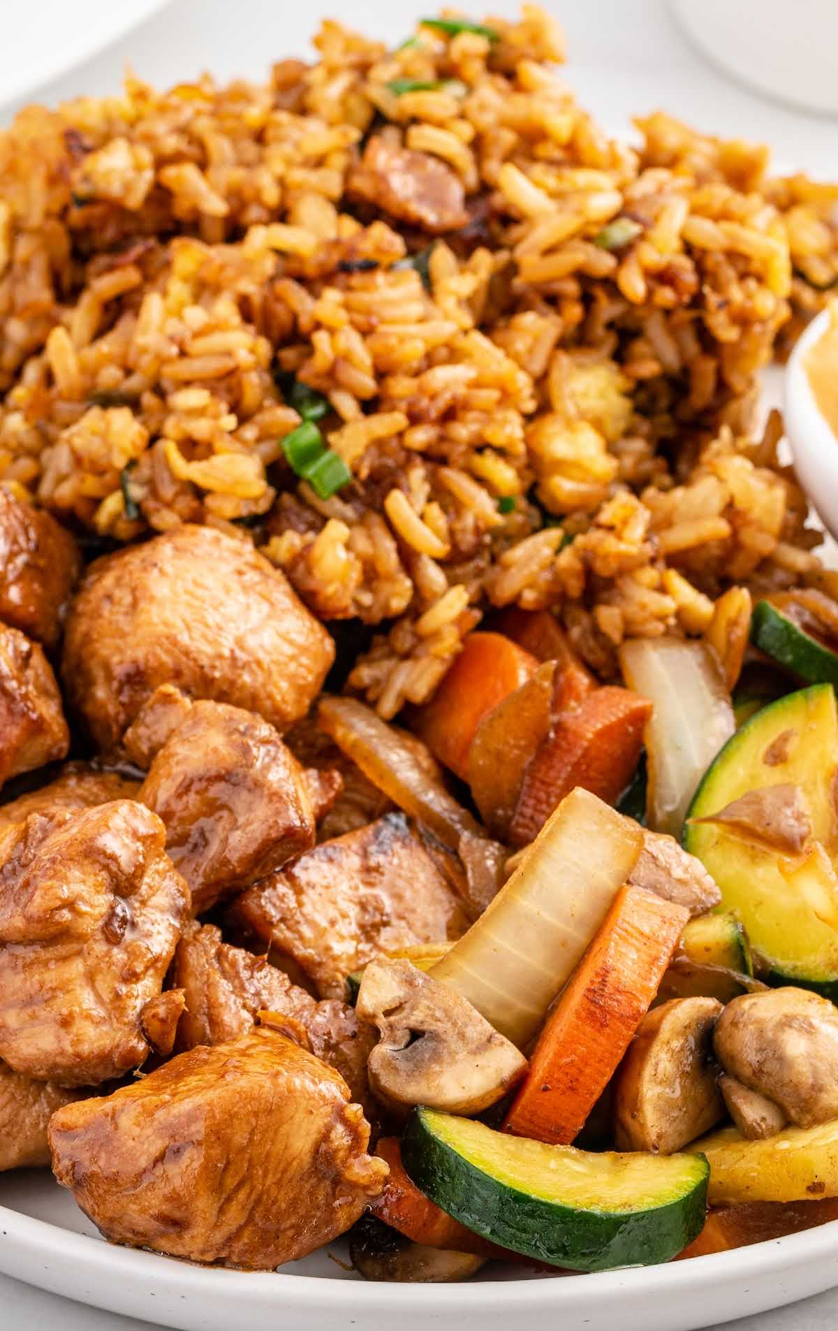 close up shot of a plate of Benihana Hibachi Chicken served with rice and vegetables