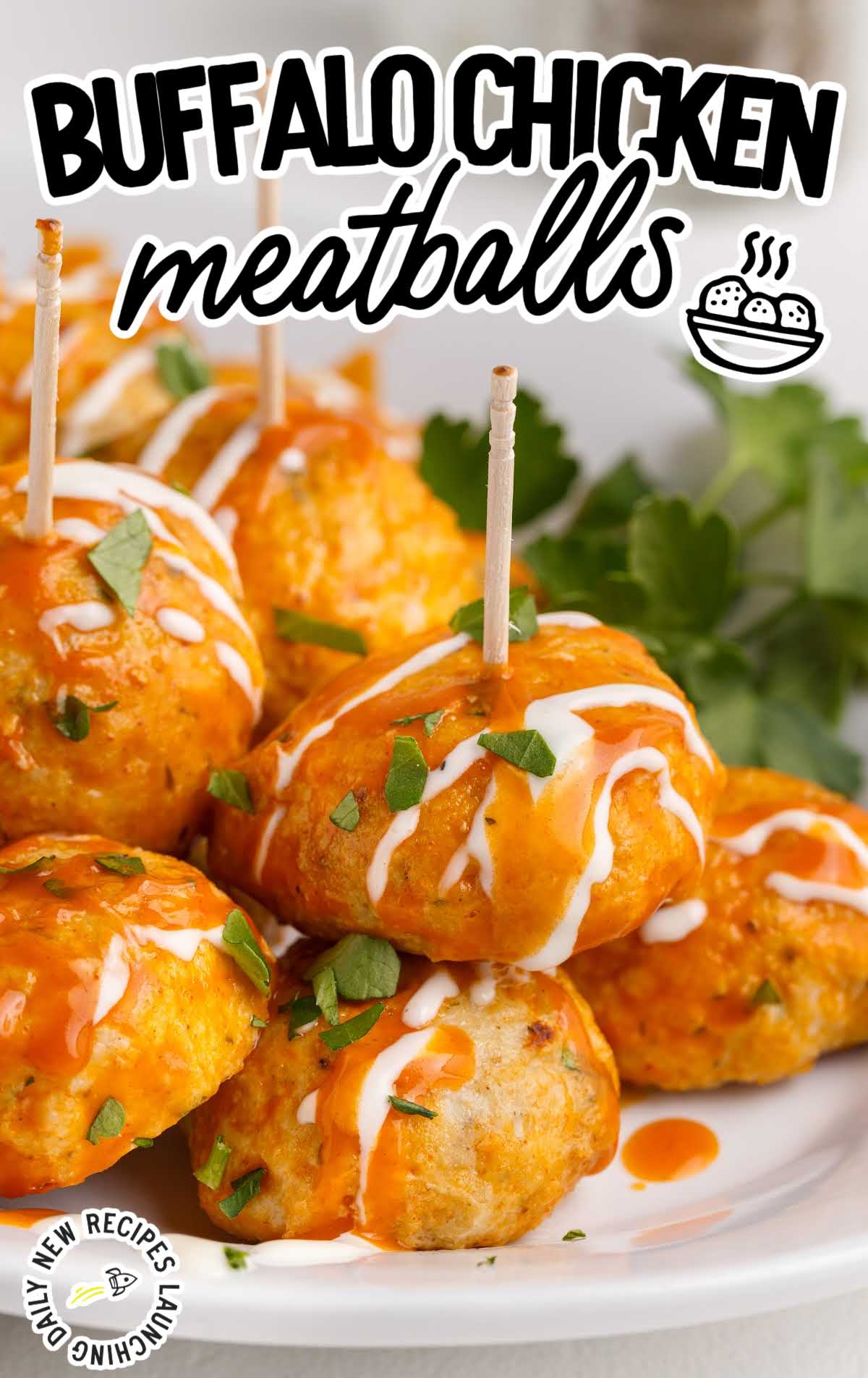 close up shot of a plate of Buffalo Chicken Meatballs drizzled with buffalo sauce and ranch dressing and sprinkled with parsley and blue cheese crumbles