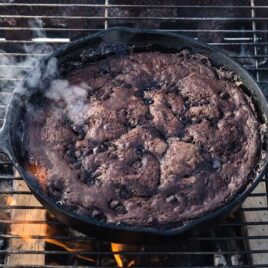 close up shot of a skillet of Campfire Chocolate Cake on a fire