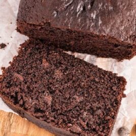 close up overhead shot of a loaf of Chocolate Bread with a slice taken off on a wooden board