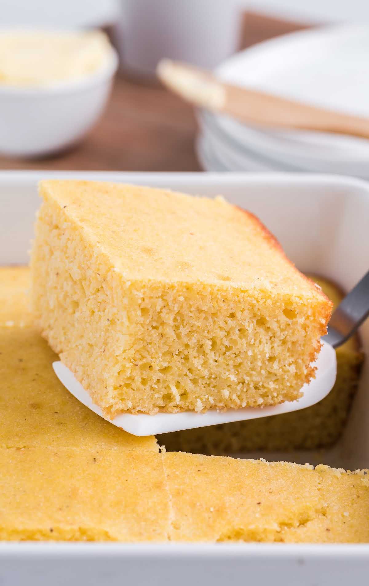 close up shot of a slice of Cornbread recipe being picked up with a spatula