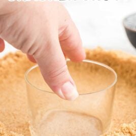 close up shot of Graham Cracker Crust being pressed down with the bottom of a cup