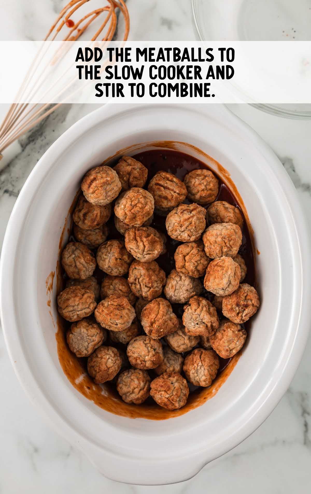 meatballs being added to the crockpot