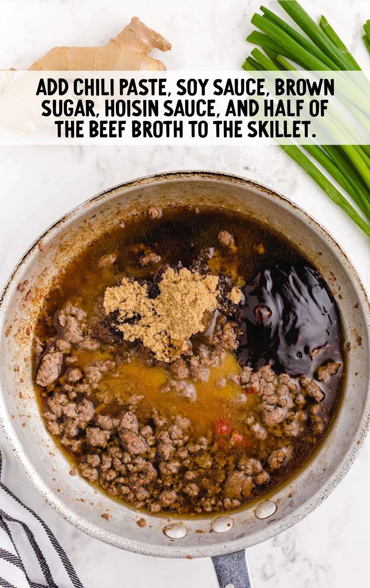 chili paste, soy sauce, brown sugar, hoisin sauce, beef broth being cooked in a skillet