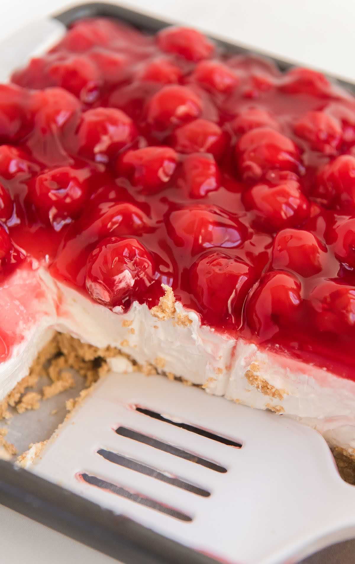 close up shot of No Bake Cherry Cheesecake in a baking pan