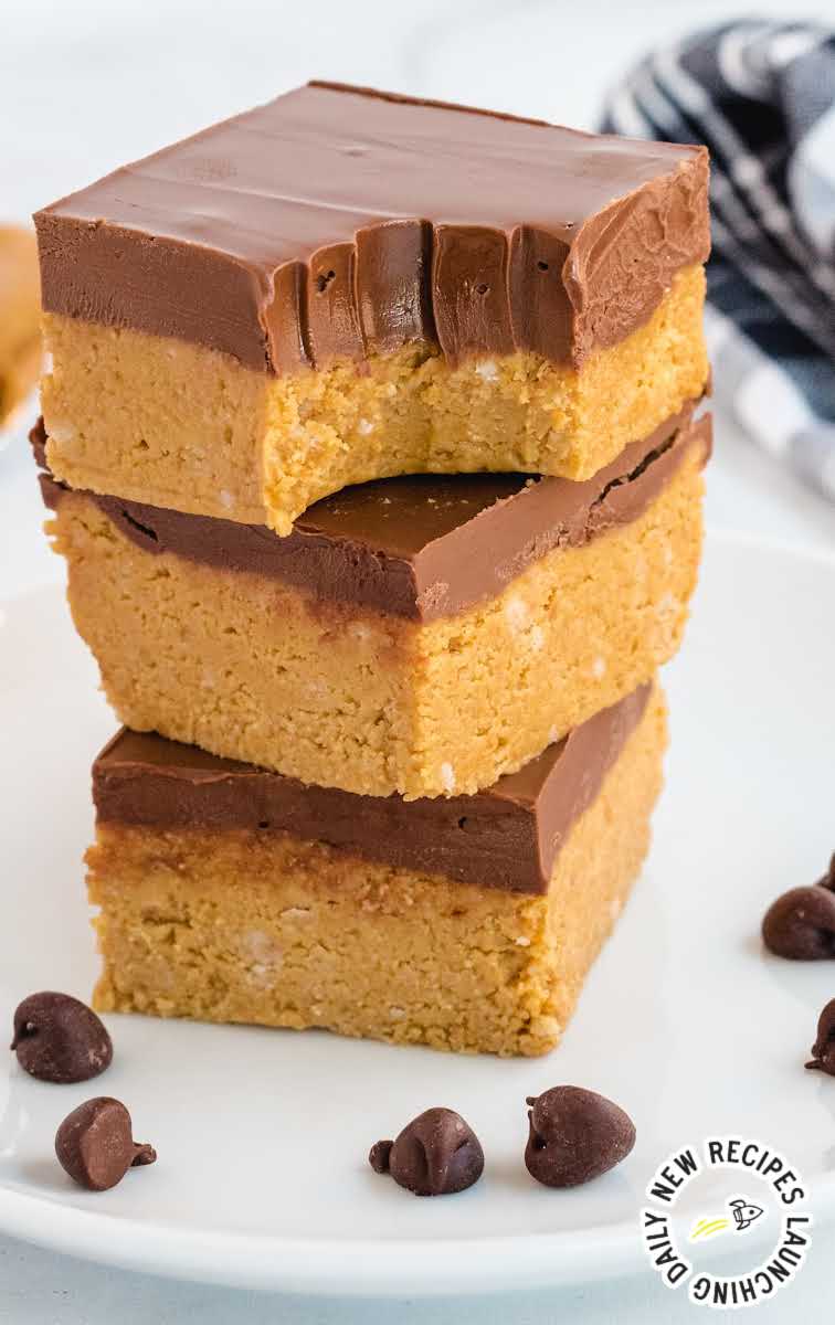 close up shot of a plate of No-Bake Peanut Butter Bars stacked on top of each other