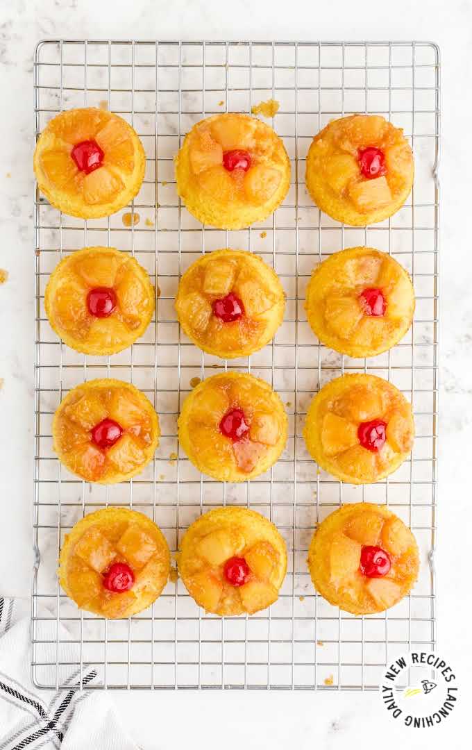 overhead shot of Pineapple Upside Down Mini Cakes in a cooling rack