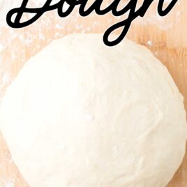 close up overhead shot of a ball of Pizza Dough Recipe on a floured wooden board