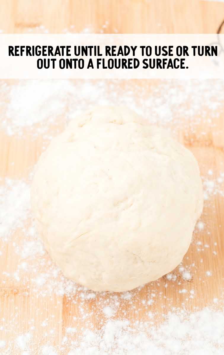 Pizza Dough Recipe process shot of dough floured on a wooden board