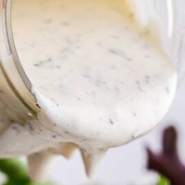 close up shot of a mason jar full of Ranch Dressing being poured