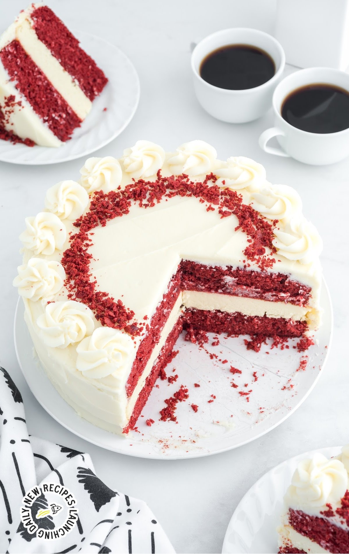 Red Velvet Cheesecake with slices missing on a serving tray