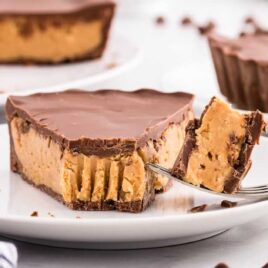 close up shot of a slice of Reese's Peanut Butter Cup Pie on a plate with a piece on a fork