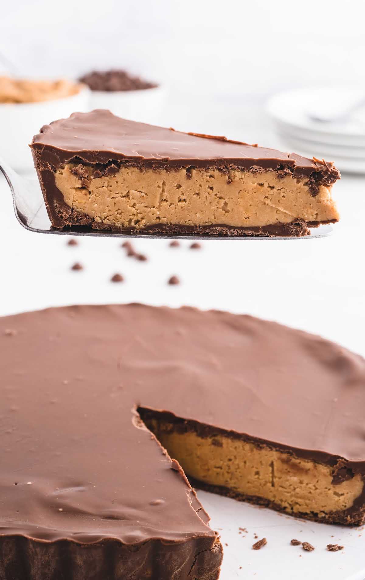 close up shot of a Reese's Peanut Butter Cup Pie with a slice taken out of it with a spatula