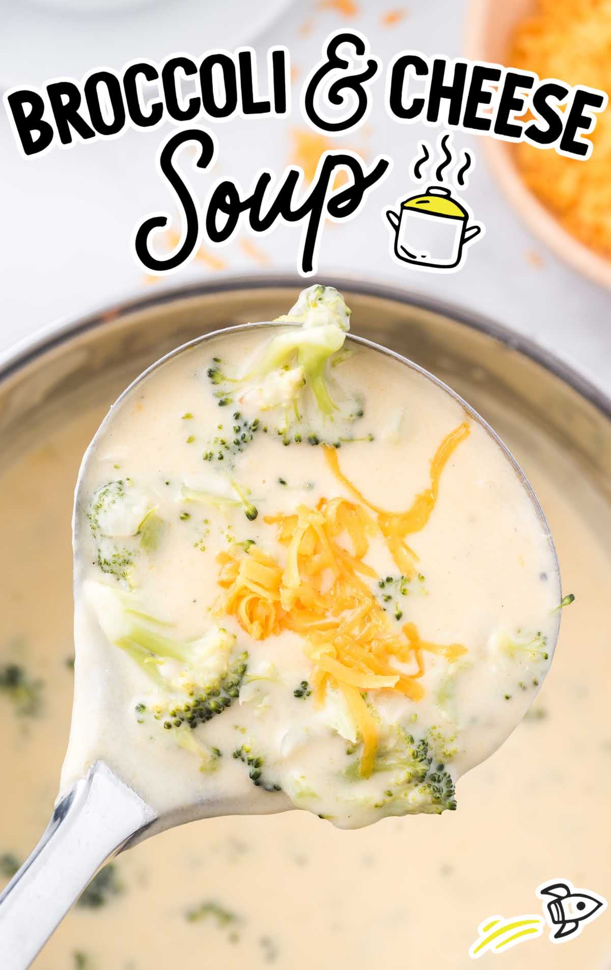 close up overhead shot of a spoonful of broccoli and cheese soup topped with shredded cheese