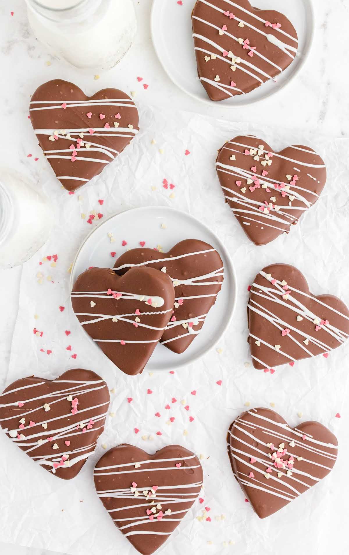 overhead shot of chocolate covered peanut butter hearts drizzled with white chocolate and topped with heart sprinkles