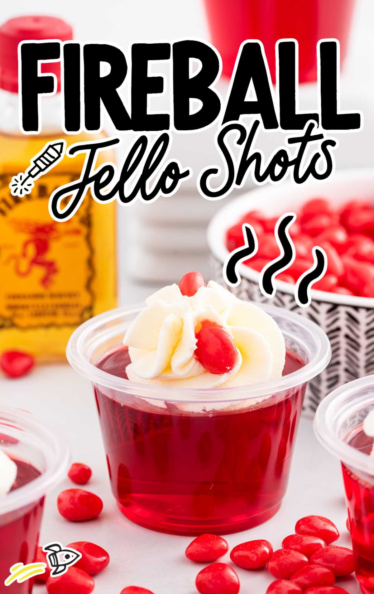close up shot of fireball jello shots topped with whipped cream and cinnamon candies