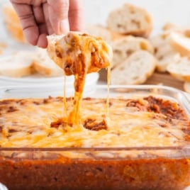 dipping bread into sloppy joe dip