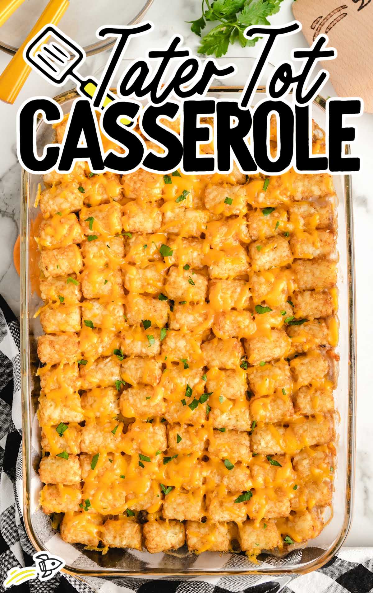 overhead shot of a baking dish of tater tot casserole garnished with parsley