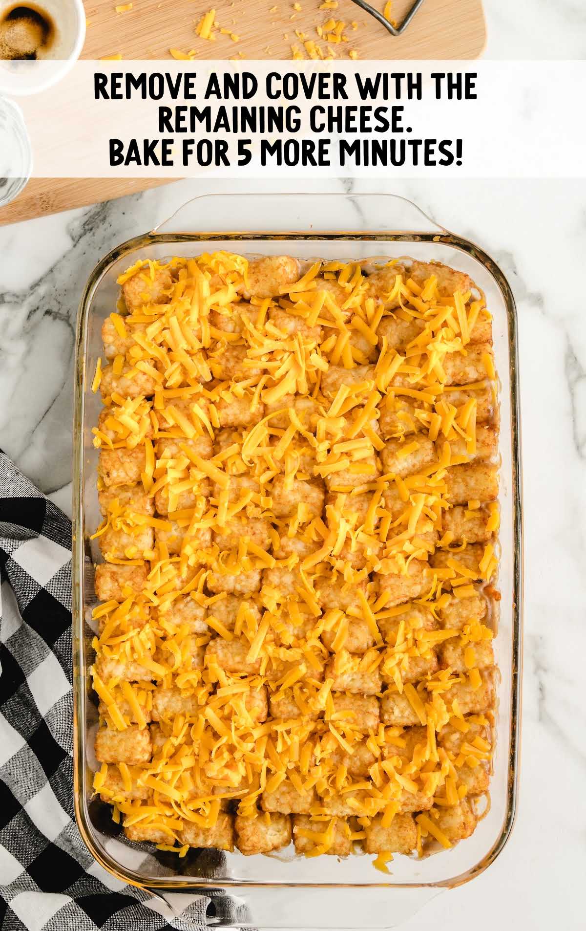 tater tots topped with shredded cheese in a baking dish