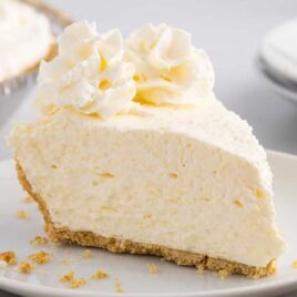 close up shot of a slice of vanilla cool whip pie on a plate