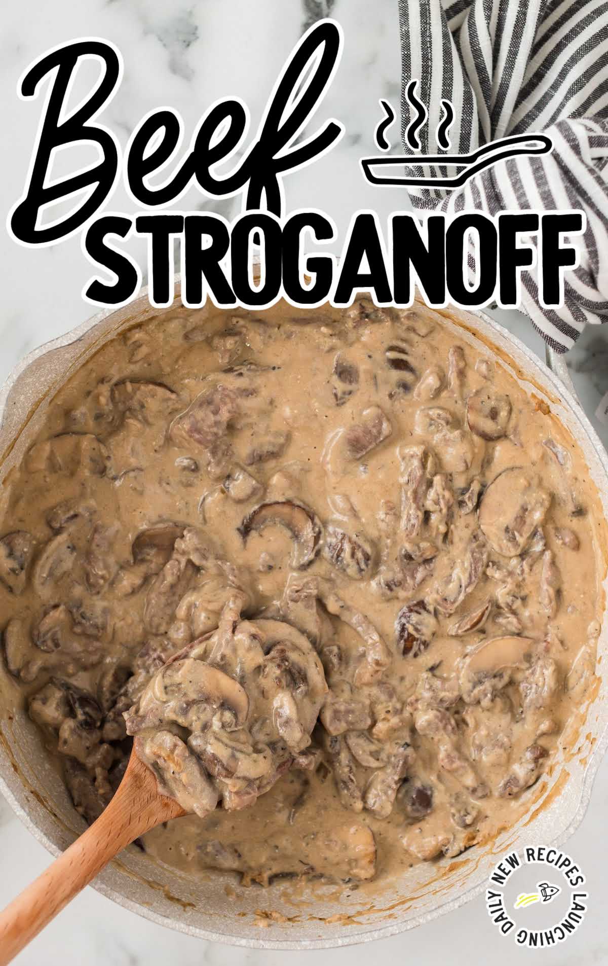 overhead shot of a pot of Beef Stroganoff with a large wooden spoon