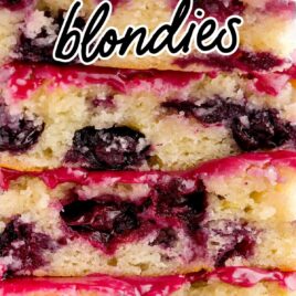 a close up shot of Blueberry-Lemon-Blondies stacked on top of each other