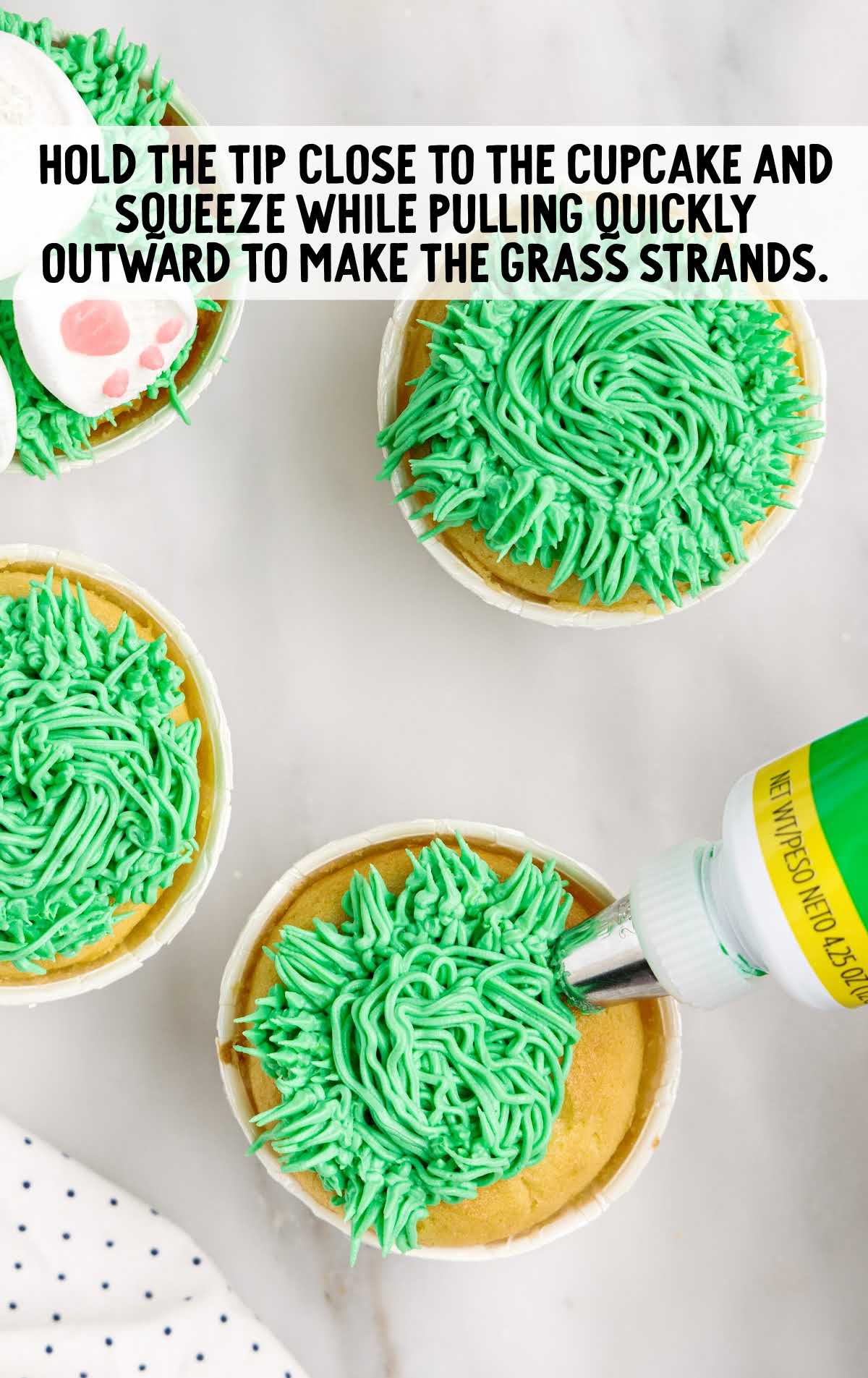 cupcakes decorated with frosting to resemble grass